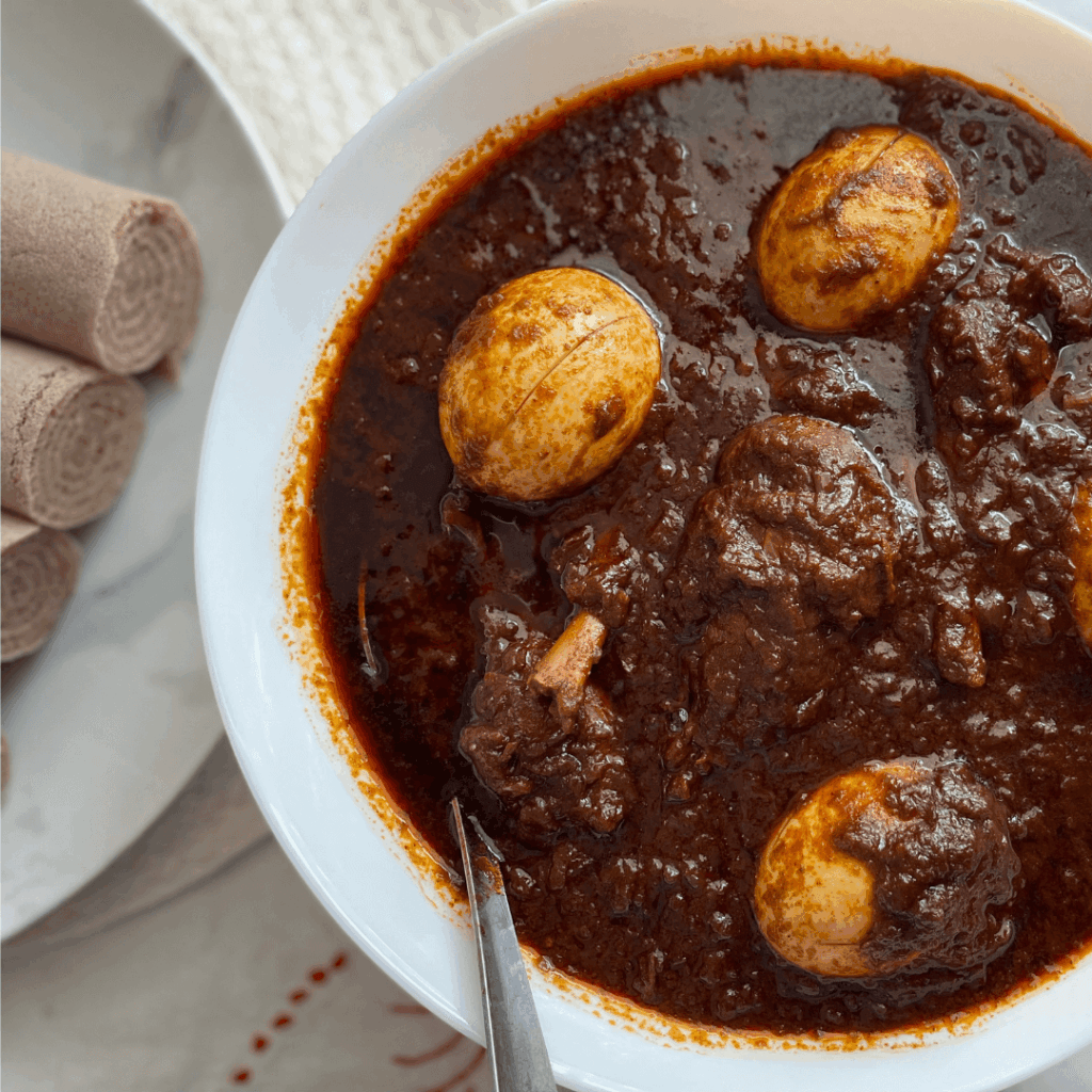 Traditional Doro Wat Ethiopian chicken stew with boiled eggs and berbere spices served with injera at Abugida Restaurant