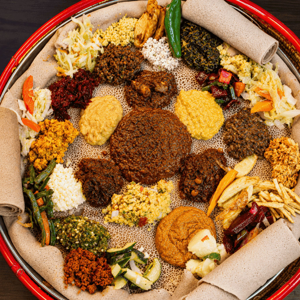 Traditional Ethiopian vegetarian injera platter with lentils, vegetables, homemade specialties, and authentic East African flavors at Abugida Restaurant