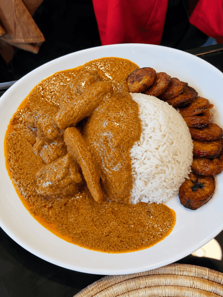 Traditional Senegalese chicken mafé served with white rice and fried plantains at Chez Bonaventure Lausanne