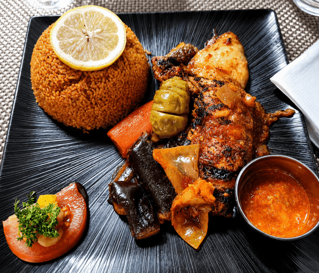 African grilled chicken with rice and homemade sauce at La Couronne d’Or