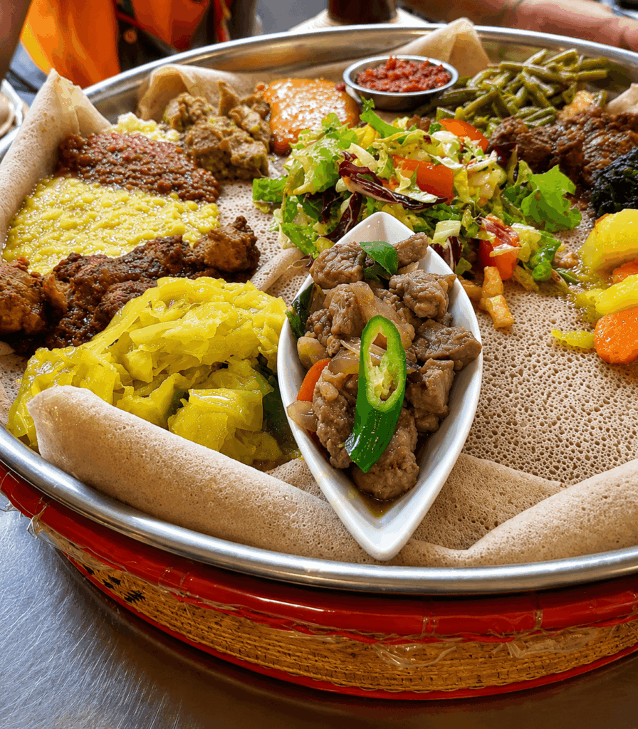 Ethiopian restaurant Bern - Traditional Ethiopian and Eritrean injera platter with meat, lentils, vegetables, and salad served at Injera Restaurant Bern