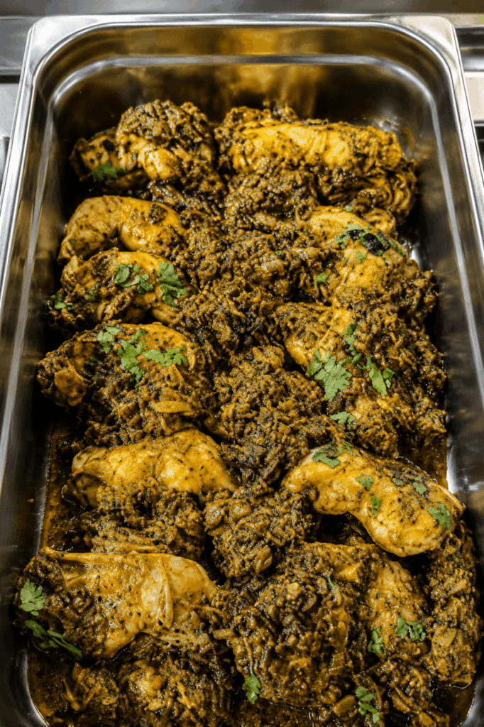 Authentic Cameroonian ndolé with chicken prepared by Cook-Yamo using traditional African recipes and spices.