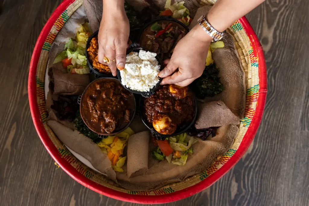 Traditional Ethiopian Doro Wat chicken stew served with injera and vegetable sides at Addis Abeba Restaurant Zürich