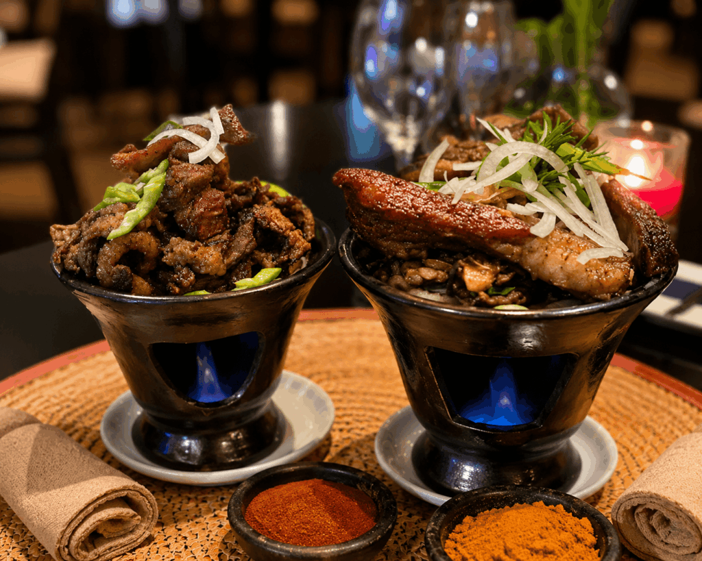 Traditional Ethiopian grilled meat specialties served on hot clay pots at Ge’ez Restaurant Lausanne