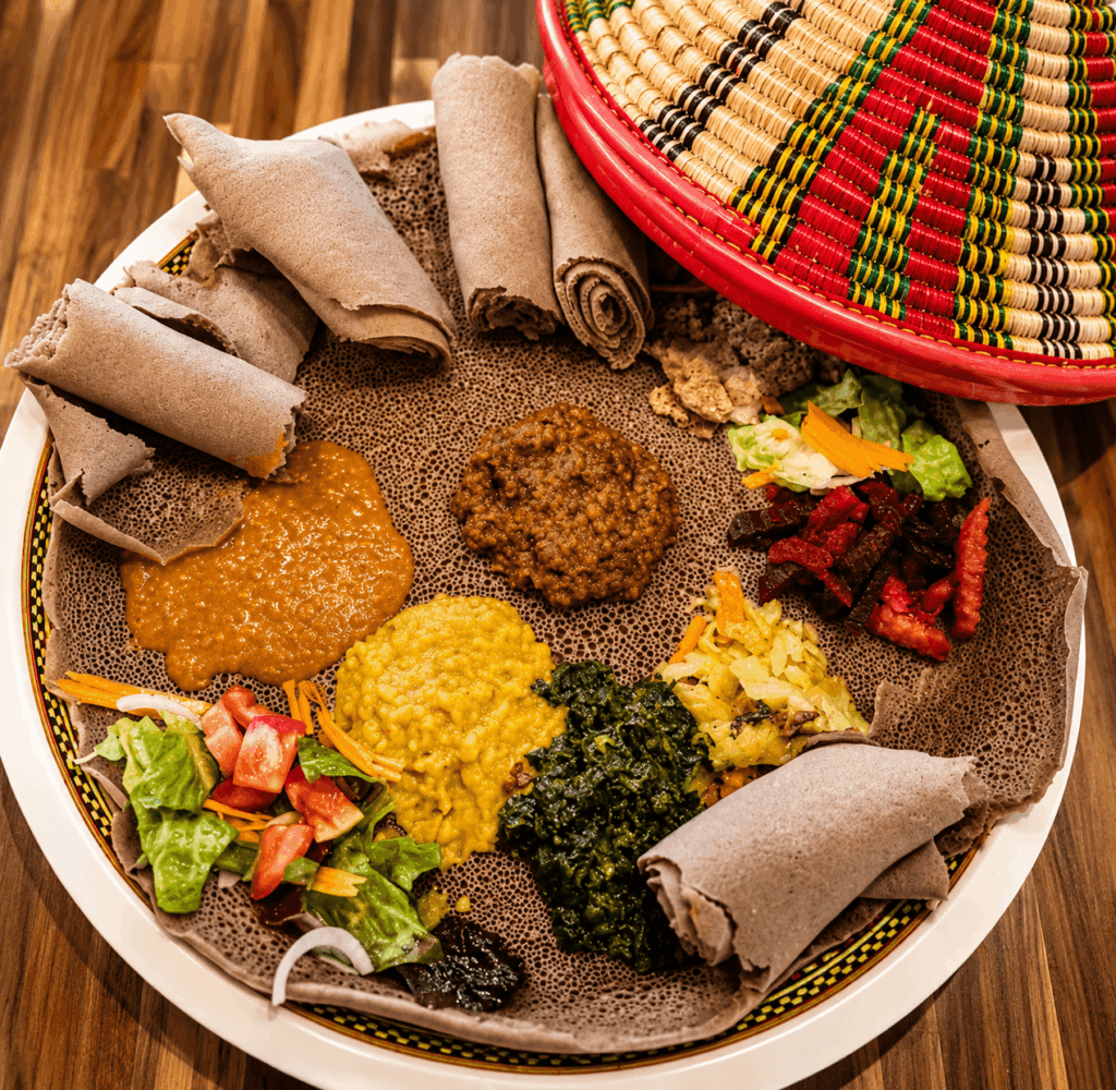 Ethiopian vegetarian specialties with lentils, spinach, cabbage, and injera served at Lalibela Restaurant in Basel