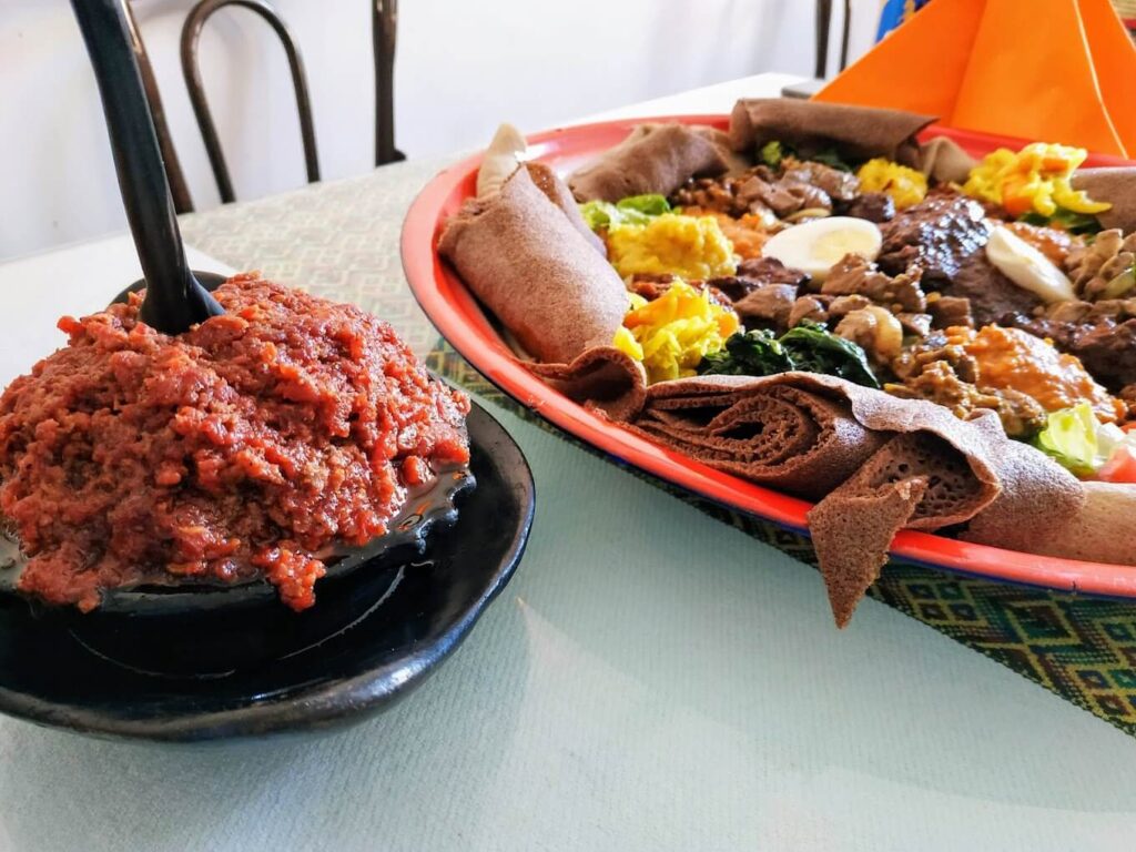 Traditional Ethiopian kitfo served with injera and mixed East African specialties at Gebeta Restaurant Basel