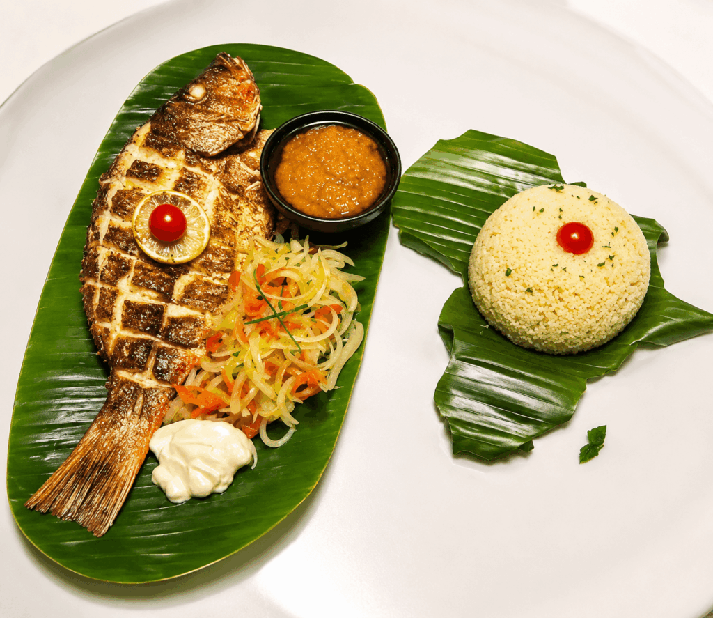 Fried fish with plantains and African sauces at La Couronne d’Or Geneva