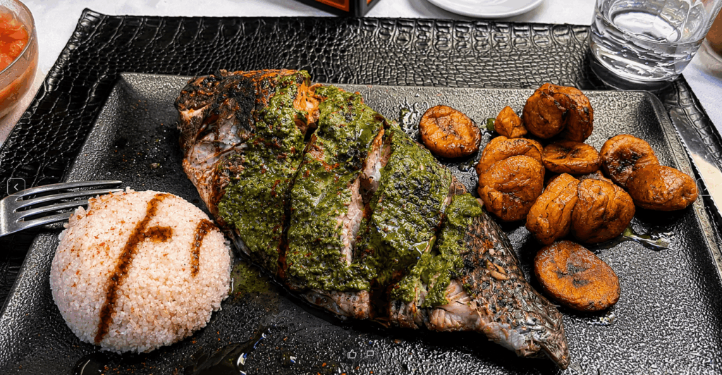 Grilled fish served with rice and fried plantains at Le Palmarin Geneva
