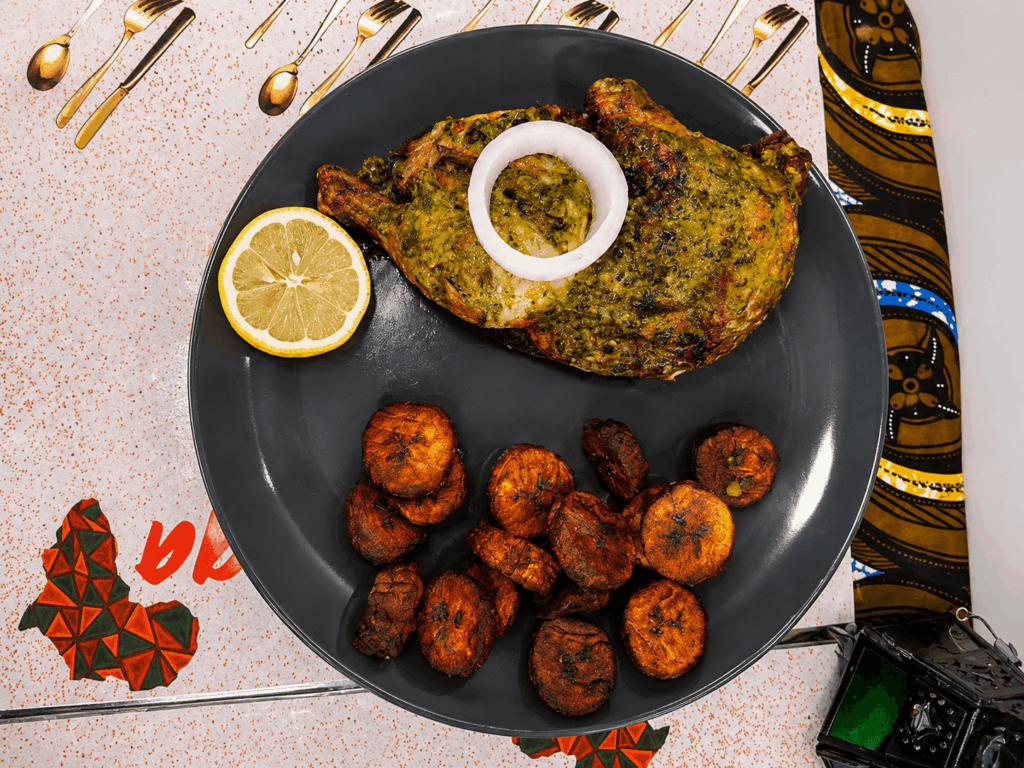 Grilled Senegalese chicken served with fried plantains and lemon at La Teranga Geneva