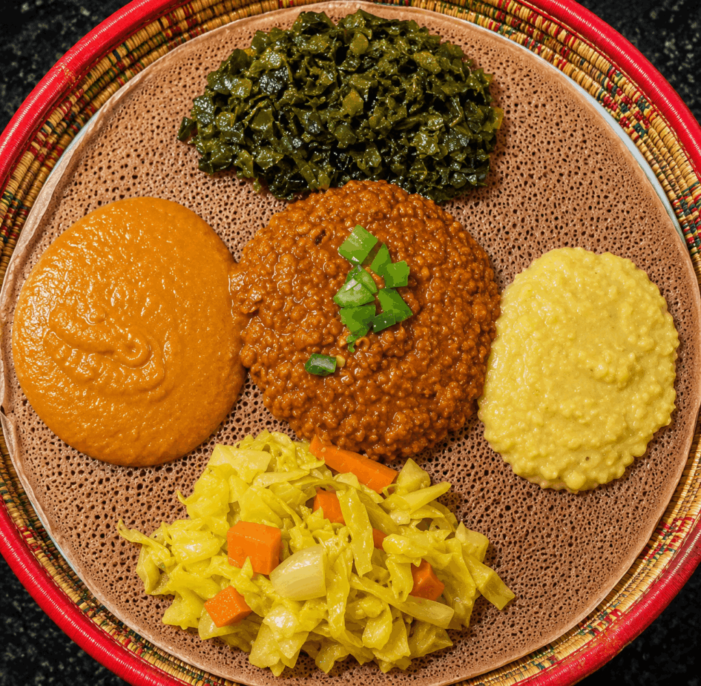 Vegetarian Ethiopian and Eritrean platter with injera, lentils, vegetables, and traditional sauces at Habesha Restaurant Zürich