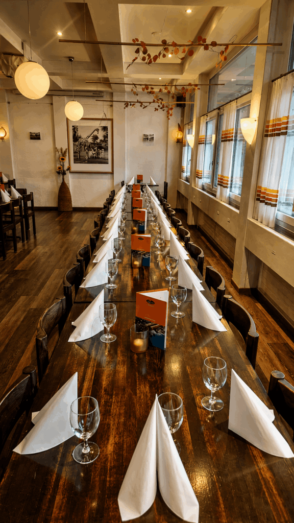 Long dining table setup inside Injera Ethiopian and Eritrean restaurant in Bern for group meals and events