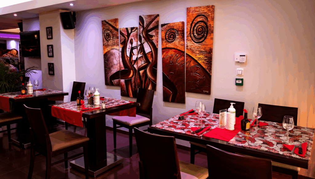Elegant dining area and warm ambiance inside Le Palmarin Senegalese restaurant in Geneva
