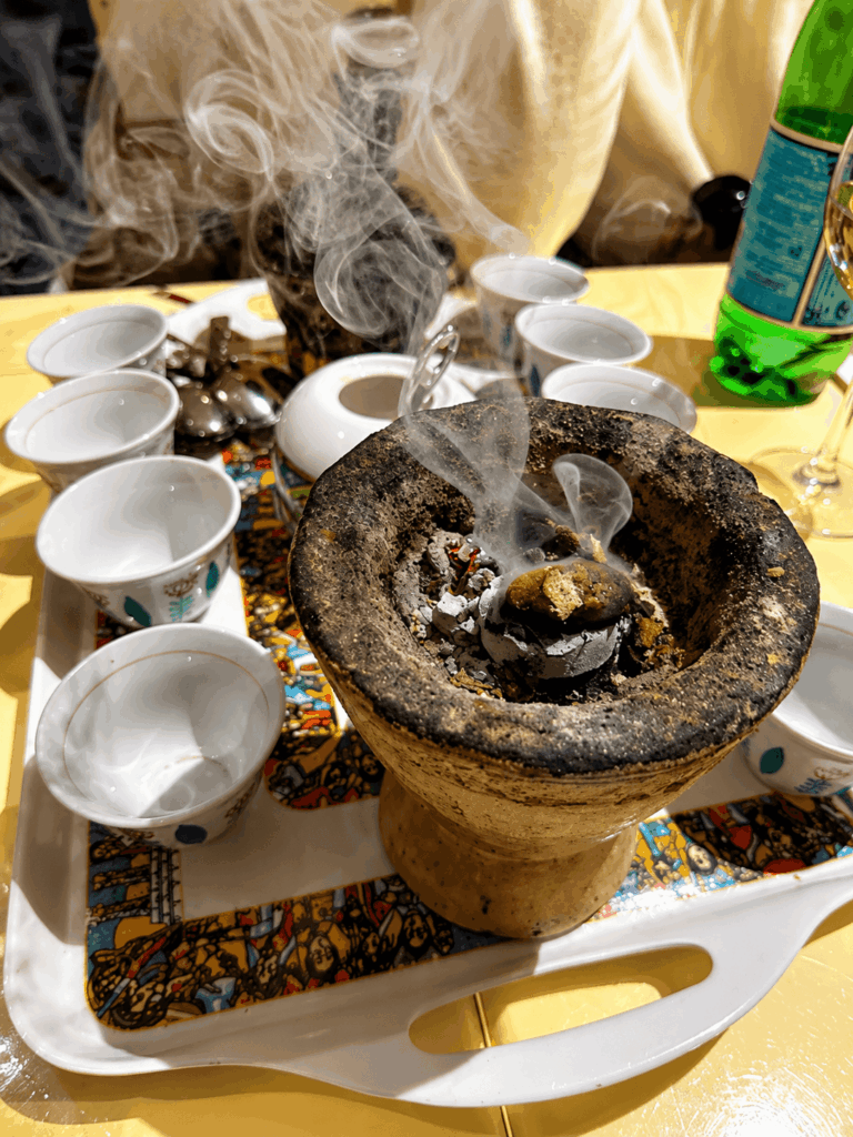 Traditional Ethiopian coffee ceremony at Mama Cuisine Habesha with incense, charcoal brazier, and authentic coffee cups