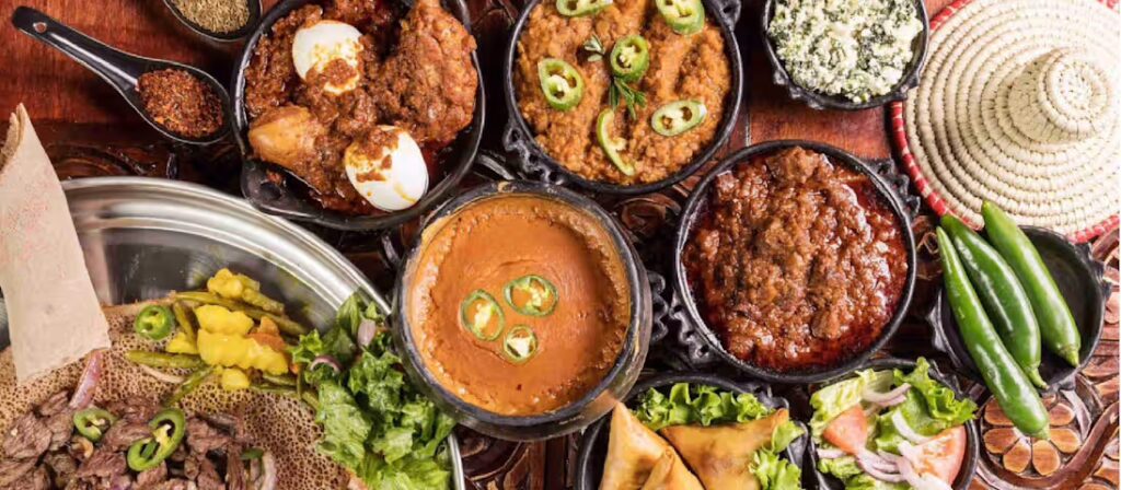 Colorful vegan Eritrean injera platter served at Hidmona Restaurant Geneva