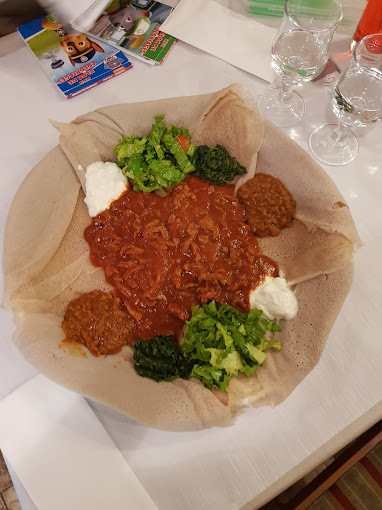 Authentic Eritrean injera served with flavorful homemade stews and vegetables at Mosaique restaurant in Geneva