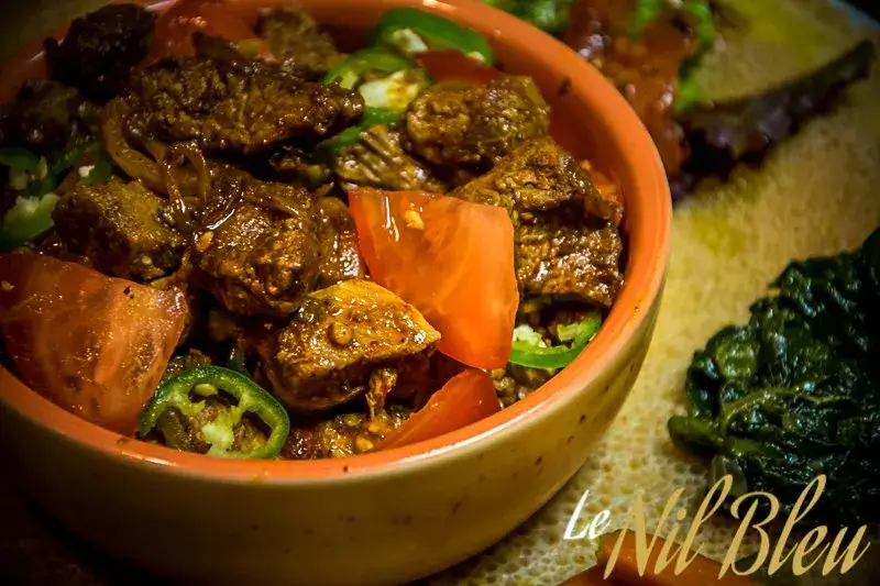 Ethiopian beef tibs with tomatoes and green chili served with injera at Nil Bleu restaurant Lausanne