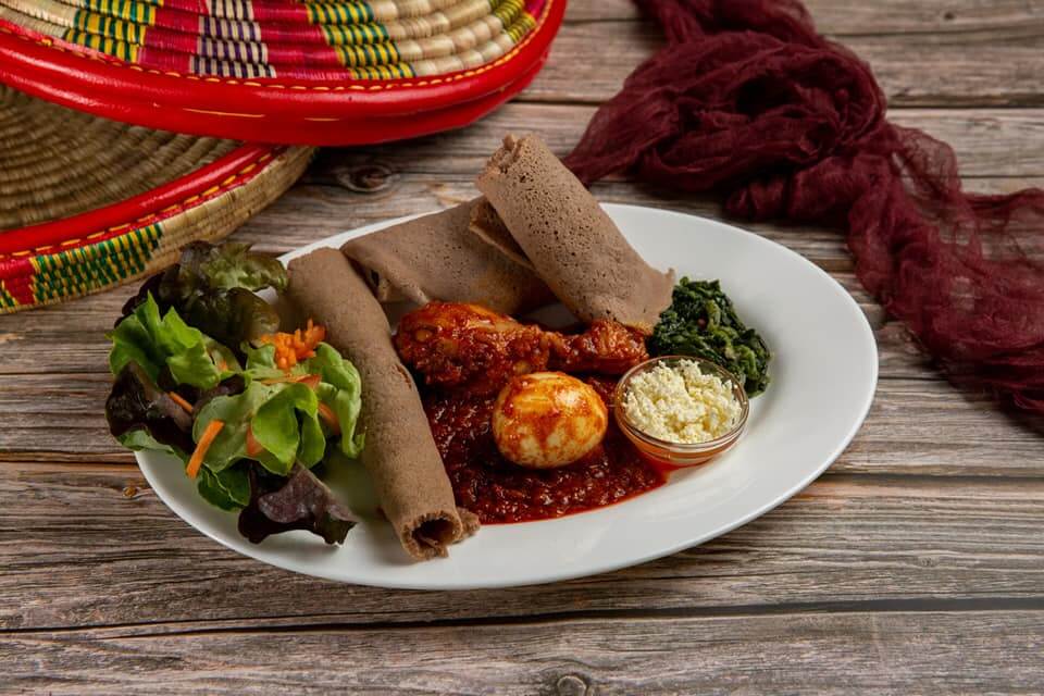 Traditional Eritrean doro wat with injera, egg, and homemade East African spices served at Raena restaurant in Lucerne