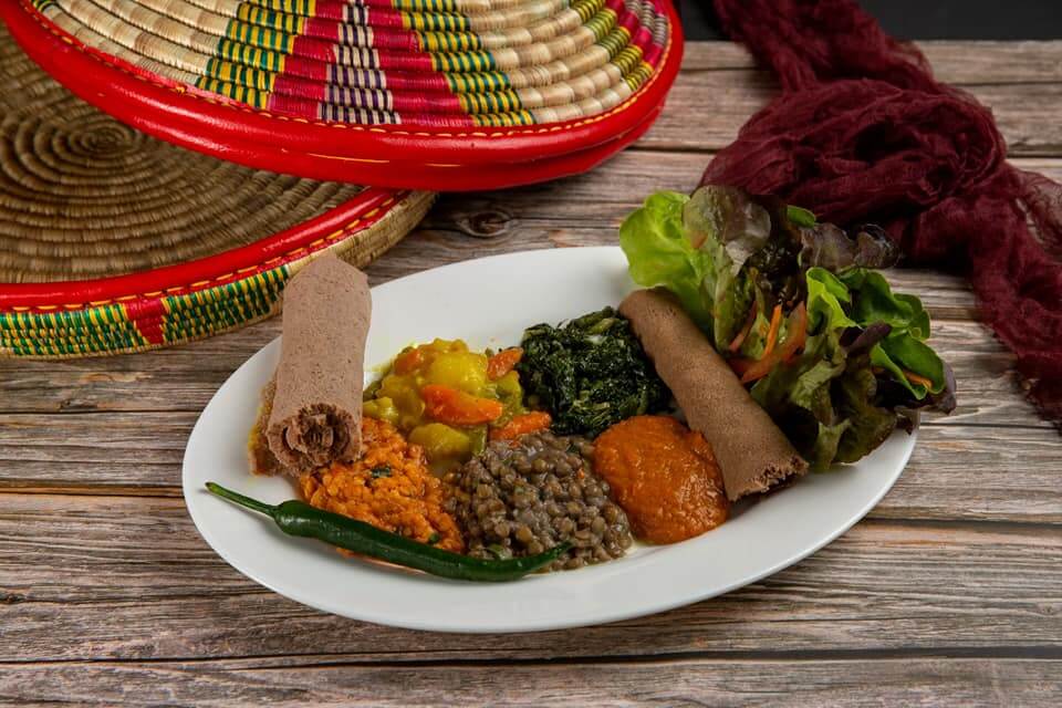 Eritrean vegetarian platter with lentils, spinach, vegetables, and injera at Raena restaurant Lucerne