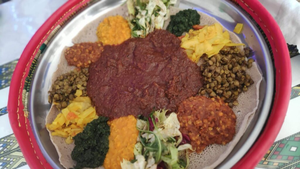 Traditional Eritrean and Ethiopian meat platter with injera and homemade vegetable sides at Red Sea Restaurant Habesha St. Gallen