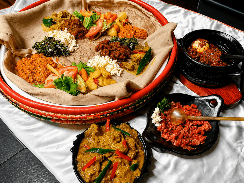 Traditional Ethiopian and Eritrean injera platter with homemade specialties, fresh vegetables, stews, and authentic East African flavors at Restaurant Marathon Switzerland