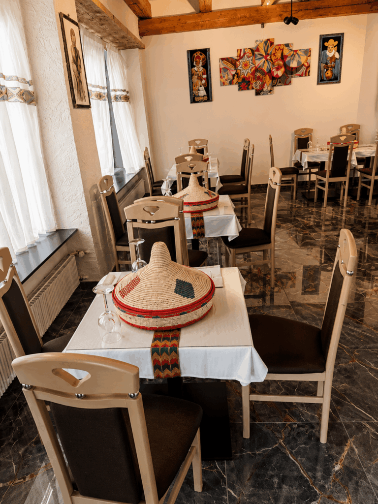 Elegant interior dining area of Savanna Eritrean & Ethiopian Restaurant with traditional Habesha decoration in Switzerland
