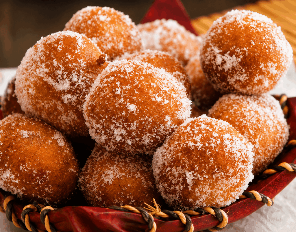 Freshly made African puff-puff coated with sugar, a popular West African dessert served at Seleyah Restaurant Geneva
