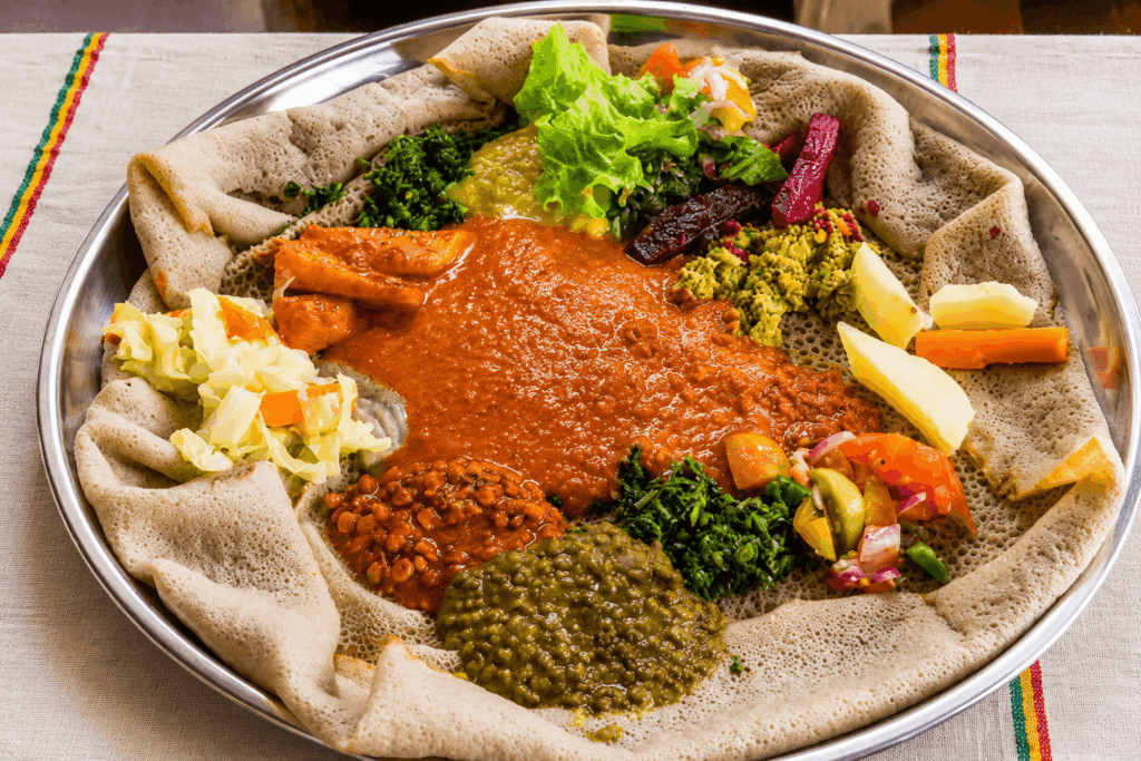 Traditional Ethiopian misir wot served with injera bread and vegetarian side dishes at Senay Restaurant Aarau