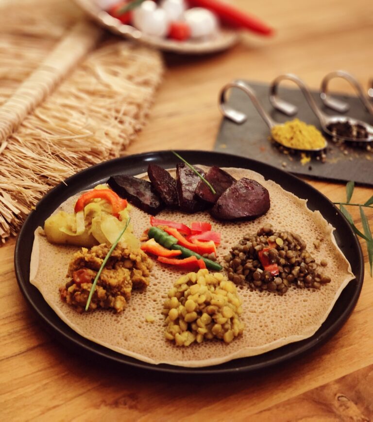 Traditional Ethiopian platter served on injera with lentils, vegetables, and homemade East African specialties at Shiro Basel