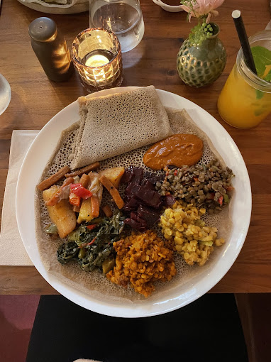 Colorful vegetarian injera platter with lentils, vegetables, and traditional Ethiopian specialties served at Shiro Basel restaurant