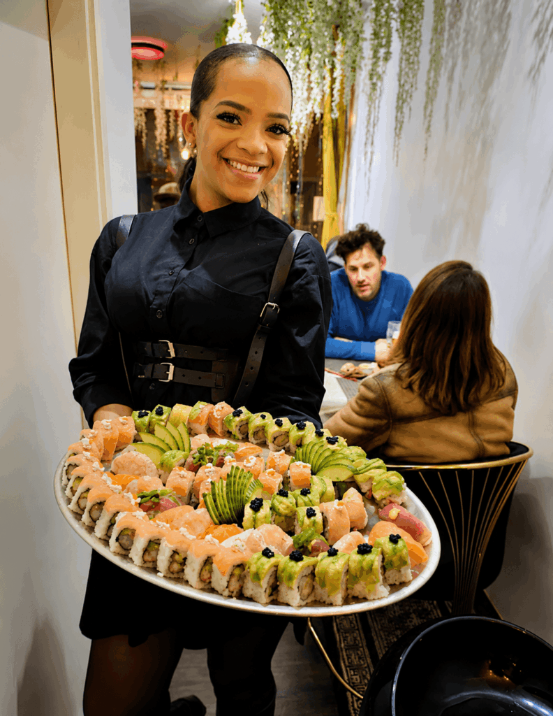 Large sushi platter served by staff at Rio Fresco du Sénégal restaurant in Geneva