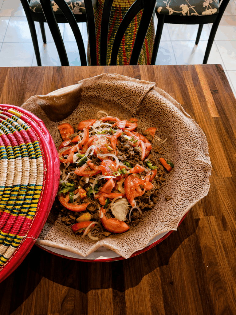 Traditional Ethiopian tibs stew served with injera bread and East African spices at Lalibela Ethiopian Restaurant Base