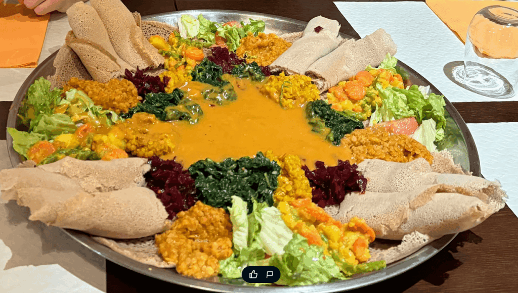 Traditional vegetarian Eritrean injera platter at Hidmona Restaurant Geneva