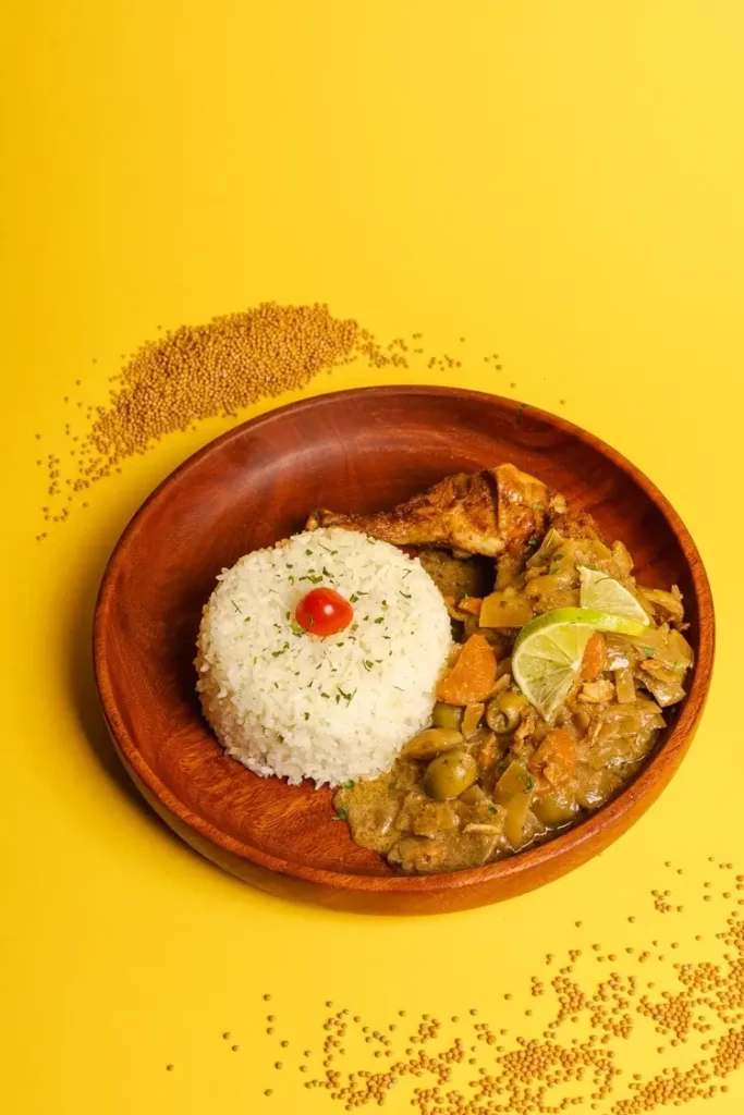 West African chicken stew with vegetables, olives, and white rice at Afrogood restaurant Lausanne