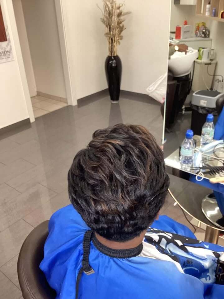Client with finished box braids at Salon Desi Cheril afro hair salon in Geneva