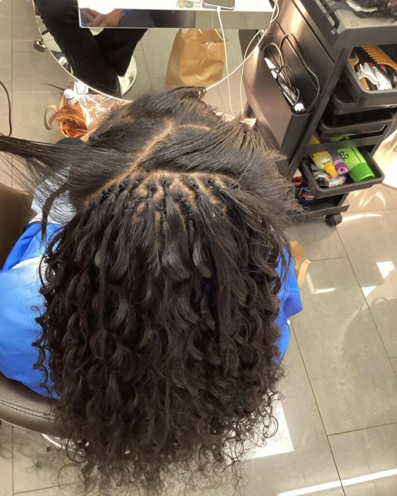 Afro braiding service in progress at Salon Desi Cheril in Geneva