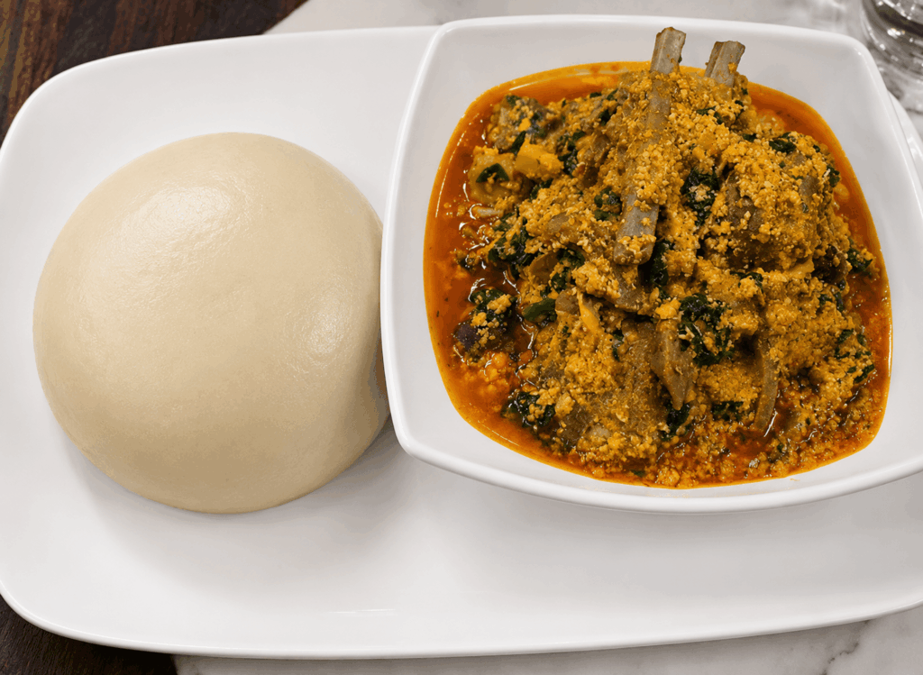 Authentic Nigerian Egusi Soup served with soft Fufu, a traditional West African specialty at Queen Idia Restaurant Zürich